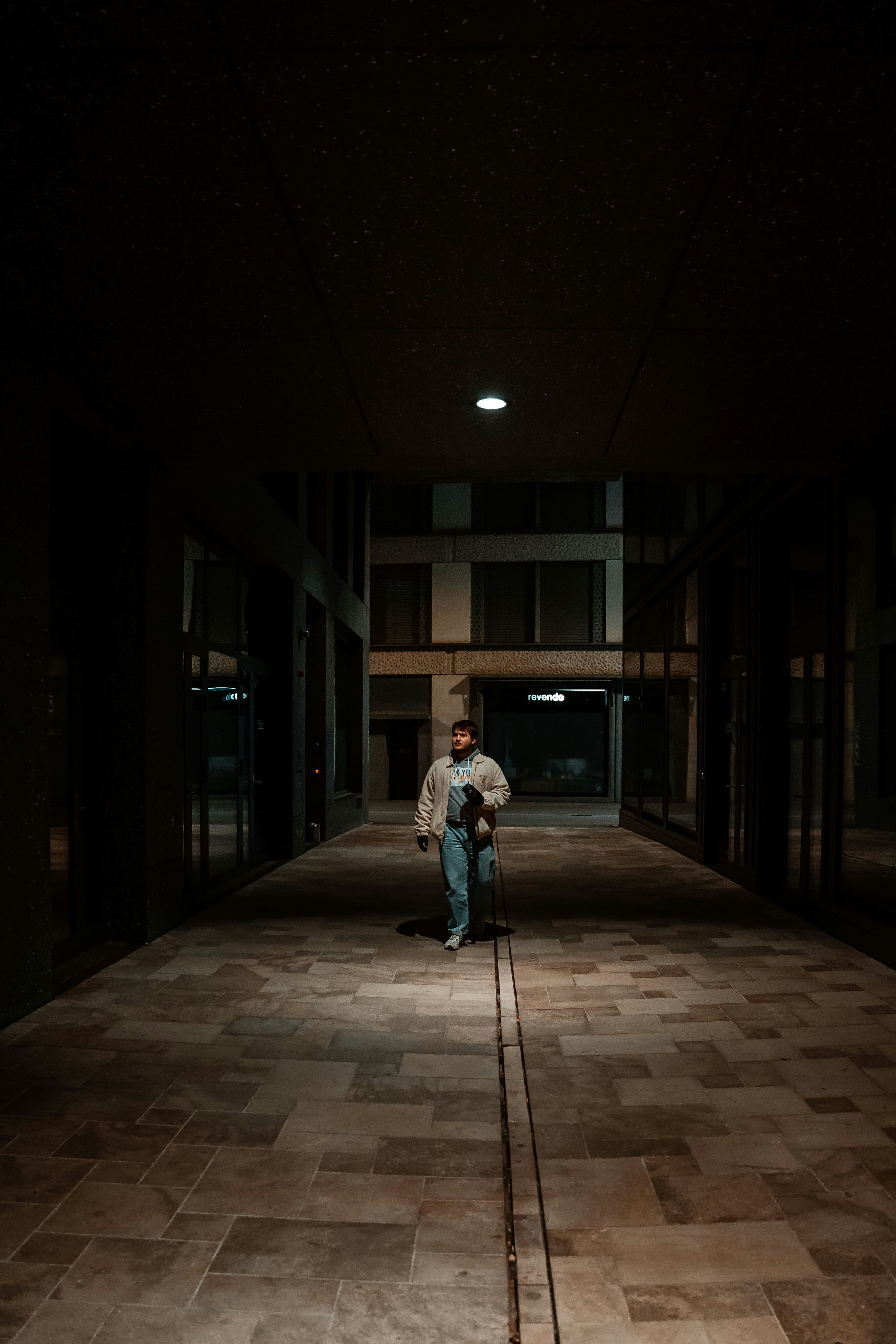 Dark corridor with a single beam of light illuminating a path forward